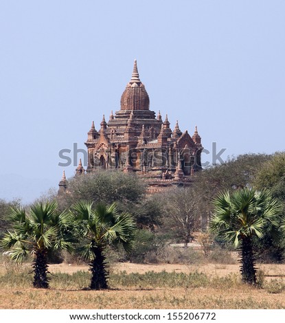 A pagoda built from brick stones sitting on the top of a little hill in the plains of Bagan. Bagan is a historic royal city in Myanmar with over two thousand preserved pagodas.