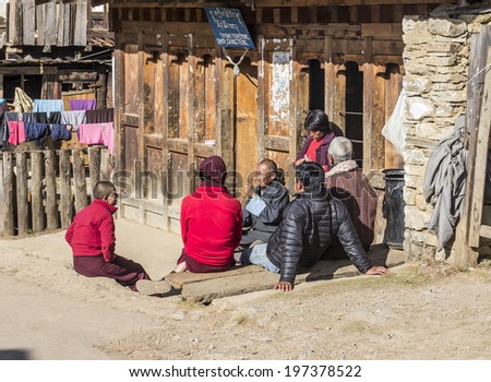 PHOBJIKHA VALLEY, BHUTAN - MARCH 03, 2014: Village people sitting together and talking at gangtey village, a beautiful village with a well known monastery in Bhutan.