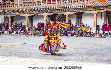 PUNAKHA, BHUTAN - MARCH 8, 2014: A masked dancer at  drupchen festival in the dzong of Punakha, Bhutan. Drupchen festival is taking place yearly in march.