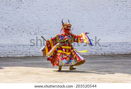 PUNAKHA, BHUTAN - MARCH 8, 2014:  masked dancer at  drupchen festival in the dzong of Punakha, Bhutan. Drupchen festival is taking place yearly in march.