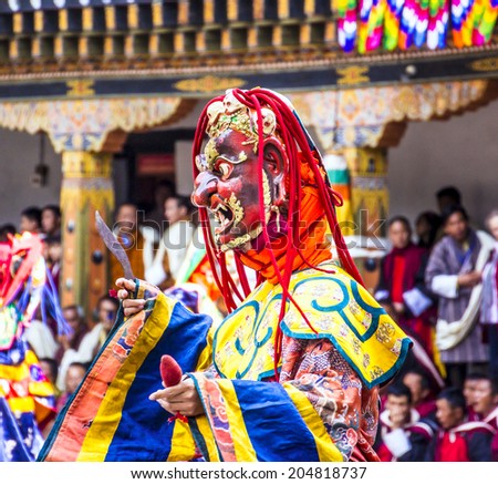 PUNAKHA, BHUTAN - MARCH 8, 2014: masked dancer at  drupchen festival in the dzong of Punakha, Bhutan. Drupchen festival is taking place yearly in march.