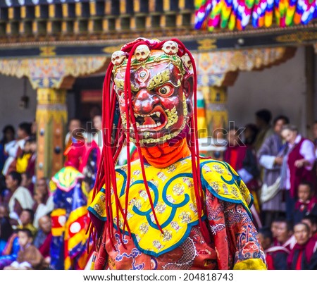 PUNAKHA, BHUTAN - MARCH 8, 2014: masked dancer at  drupchen festival in the dzong of Punakha, Bhutan. Drupchen festival is taking place yearly in march.