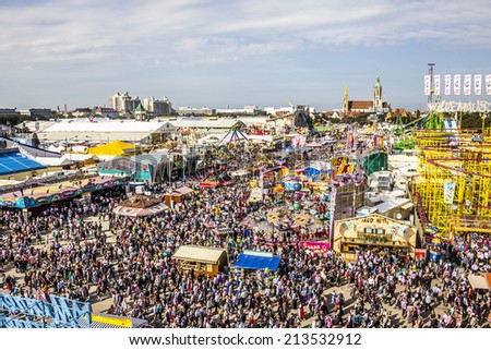 MUNICH, GERMANY - SEPTEMBER 23, 2014: Oktoberfest Munich: A bird\'s eye view over beer tents, fairground attractions and masses of people.