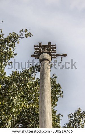 LOIKAW, MYANMAR - FEBRUARY 7, 2015: Tops of one of the poles at an animist ritual place near Loikaw, Myanmar. People put some of the harvest beneath the poles as a thanksgiving to the gods.
