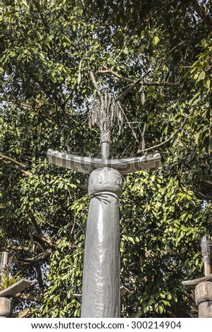 LOIKAW, MYANMAR - FEBRUARY 7, 2015: Tops of one of the poles at an animist ritual place near Loikaw, Myanmar. People put some of the harvest beneath the poles as a thanksgiving to the gods.