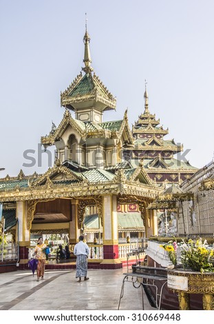 DAWEI, MYANMAR - FEBRUARY 16, 2015: The beautiful golden pagoda of Dawei in the south of Myanmar. Lokal people are going to worship the buddha.