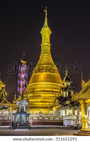 The beautiful golden pagoda of Dawei in the south of Myanmar is illuminated at night.