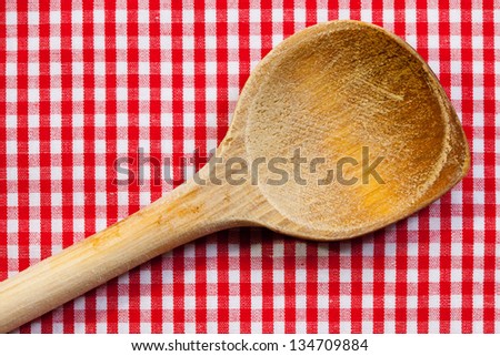 Antique wooden spoon for cooking with red white background