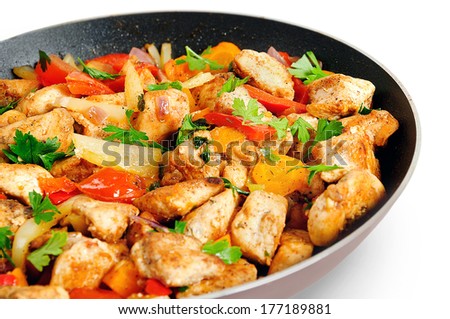Isolated chicken with vegetable on frying pan