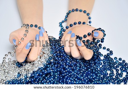 Hand with beads on table