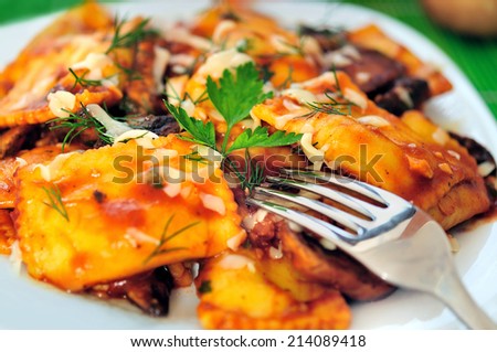 Plate with ravioli on table