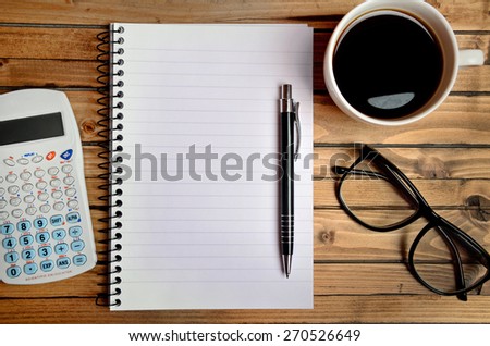 Coffee and notebook on the office desk