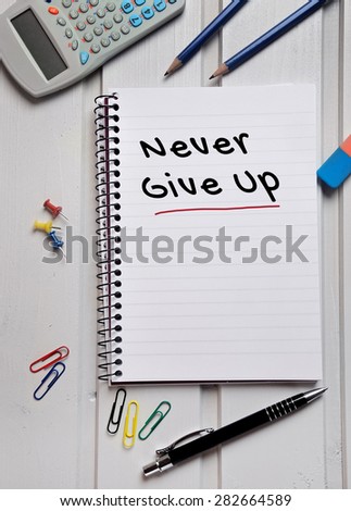 Never give up word on notebook page