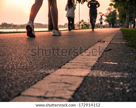 Running On Road Closeup On Shoe. Fitness Sunrise Jog Workout Wellness Concept.