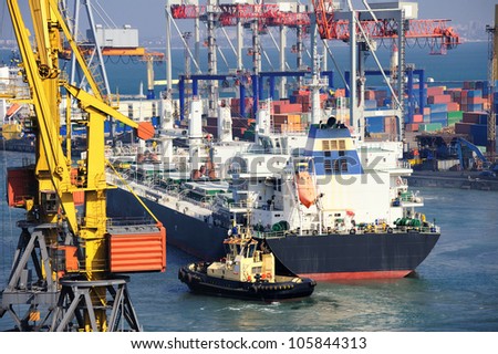 cargo ship and tug boat in port