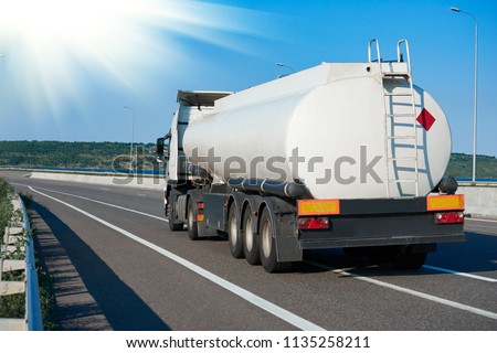 tank truck rides on highway, white blank color, rear view, one object on road