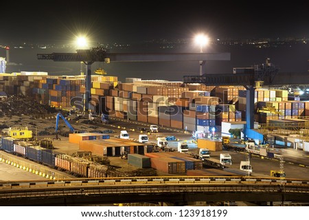 night industrial port.  containers and trucks