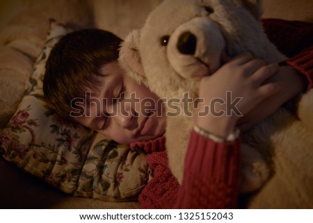 boy sleep in bed with bear toy
