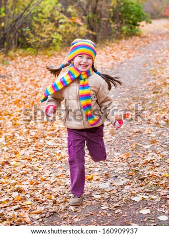girl runs in autumn park