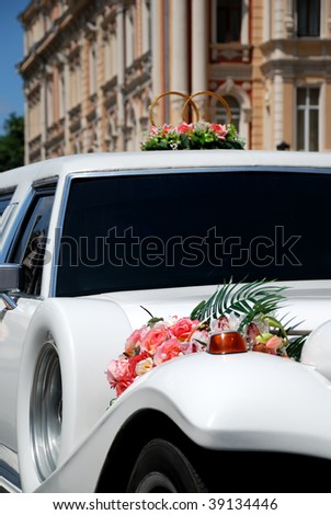 White wedding limousine decorated with flowers