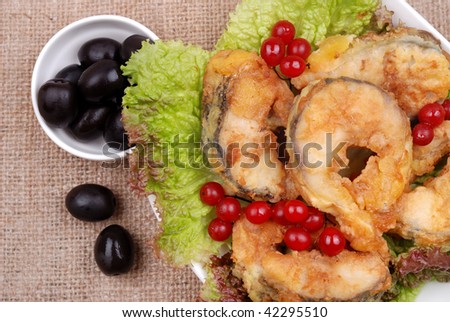 Food. The served dish from fish, salad, olives and a cranberry