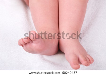 Children\'s legs on a soft light towel