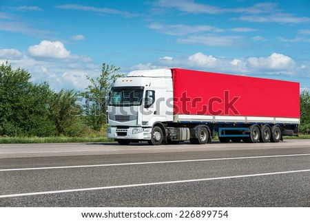 red truck on road. cargo transportation