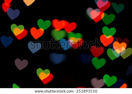 red and green heart bokeh on dark background