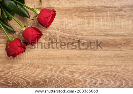 Red rose flower on wood background