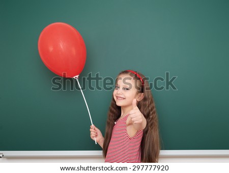 girl with balloon near the school board
