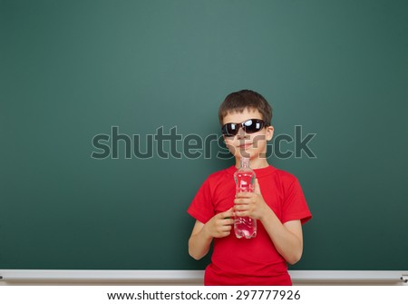 boy with water bottle near the school board