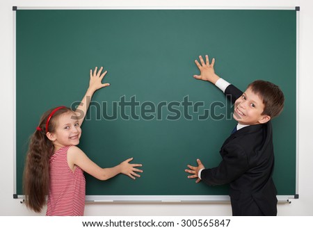 boy and girl write on school board