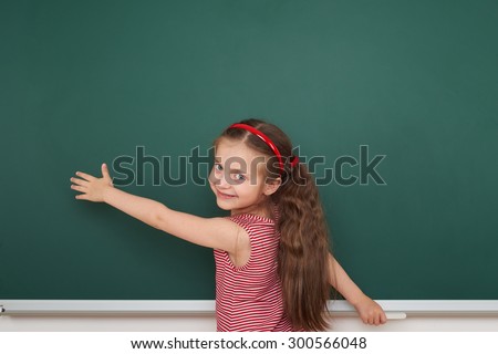 Schoolgirl write on the school board