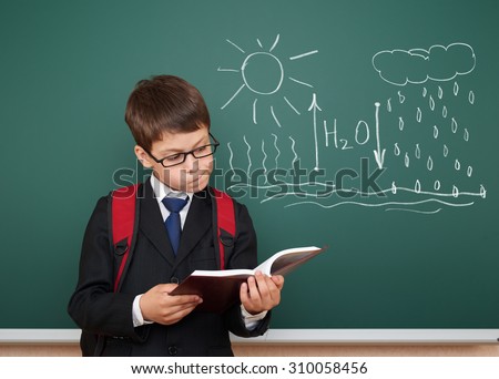 school boy read book about circulation of water