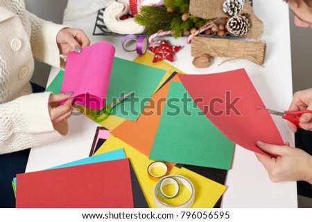 couple making decorations from paper for Valentine day, top view - romantic and love concept