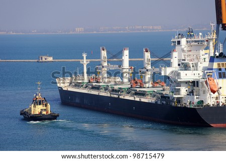 cargo ship and tug boat