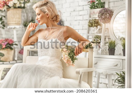The beautiful  woman posing in a wedding dress