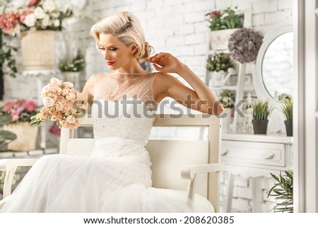 The beautiful  woman posing in a wedding dress