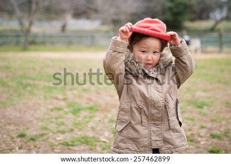 Girl take off a knit hat