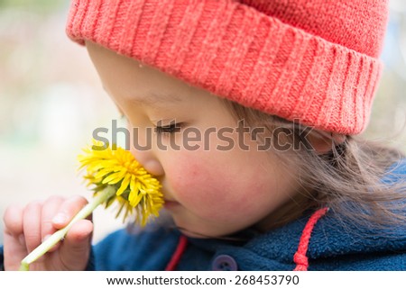 Girl smell the scent of dandelion flower