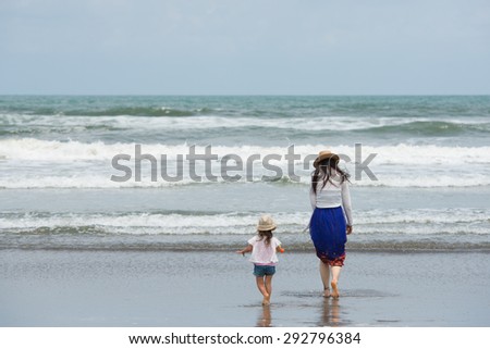 Mother and daughter playing in the sea