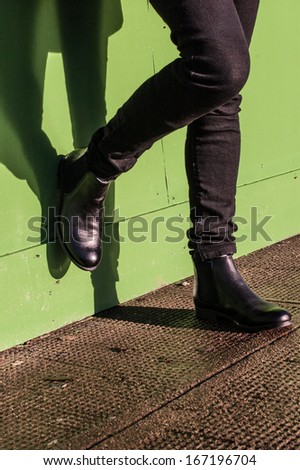 Model wearing black trousers and ladies vintage boots with low heel (short Chelsea ankle) on the street