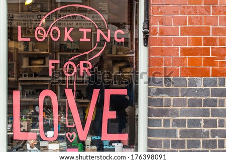 Looking for love written in pink ink on a shop window in Shoreditch (London)