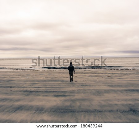 Picture of a man from behind walking on a beach in Scotland (UK). Watercolor Effect.