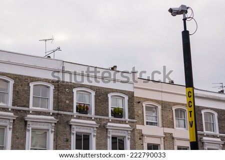 CCTV camera on a pole with apartments in the background in a street in Notting Hill, London, UK.