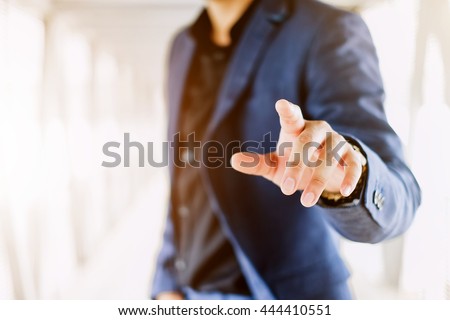 Blur businessman pushing on a touch screen interface