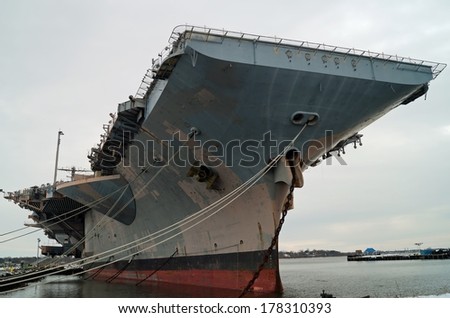 PHILADELPHIA, PENNSYLVANIA - February 16, 2014:   Decommissioned aircraft carrier USS John F. Kennedy in the NAVSEA Inactive Ships On-site Maintenance facility at the Philadelphia navy yard.