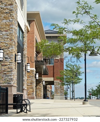 An outdoor American suburban shopping mall featuring upscale shops and restaurants.