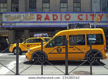 NEW YORK, NEW YORK - June 29, 2014: Radio City Music Hall. Taxis line the street in front of the iconic Radio City Music Hall in New York City.