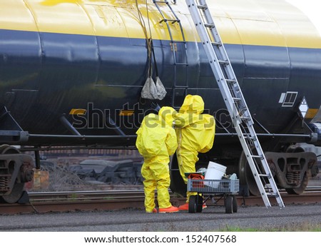 Fire departments and emergency response teams will conduct disaster preparedness drills. These HAZMAT team members are passing tools up to the others on the rail tanker to repair the chemical leak.